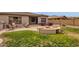 Lawn and patio area featuring a built-in fire pit and grill at 2514 E Espada Trl, Casa Grande, AZ 85194