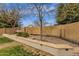 Landscaped backyard featuring a hammock, rock garden, and lush green lawn at 2514 E Espada Trl, Casa Grande, AZ 85194