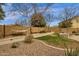 Backyard featuring hammock, gravel beds, grass lawn, and garden at 2514 E Espada Trl, Casa Grande, AZ 85194