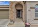 Welcoming front entryway featuring stone accents, a secure gate, and a neutral color scheme at 2514 E Espada Trl, Casa Grande, AZ 85194