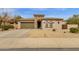 Inviting home with a two-car garage, stone accents, desert landscaping, and a covered front entry at 2514 E Espada Trl, Casa Grande, AZ 85194