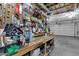 Workbench and storage in a well-organized two-car garage, ceiling fan and overhead rack at 2514 E Espada Trl, Casa Grande, AZ 85194