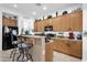 Stylish kitchen with bar seating, dark appliances, and wood cabinets at 2514 E Espada Trl, Casa Grande, AZ 85194