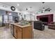 Modern open kitchen with a breakfast bar overlooking the cozy living room at 2514 E Espada Trl, Casa Grande, AZ 85194