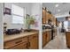 Kitchen area with light countertops, tile flooring, and wooden cabinets with black hardware at 2514 E Espada Trl, Casa Grande, AZ 85194