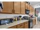 Functional kitchen featuring stainless steel appliances, ample counter space, and wood cabinetry at 2514 E Espada Trl, Casa Grande, AZ 85194