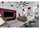 Well-lit living room with comfortable seating, a large screen TV, and stylish decor at 2514 E Espada Trl, Casa Grande, AZ 85194