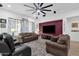 Spacious living room with a large ceiling fan, comfortable seating, and a wall-mounted TV at 2514 E Espada Trl, Casa Grande, AZ 85194