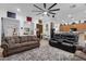 Bright and airy living area with a large ceiling fan, comfortable sofas, and an open layout at 2514 E Espada Trl, Casa Grande, AZ 85194