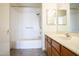 Bathroom featuring a shower-tub combo, white tile, a sink and a mirror at 2910 W Marconi Ave # 105, Phoenix, AZ 85053