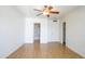 Bright bedroom featuring hardwood floors with easy access to an ensuite bathroom and closet space at 2910 W Marconi Ave # 105, Phoenix, AZ 85053