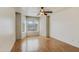 Bright bedroom featuring hardwood floors, ceiling fan and a large window allowing for ample natural light at 2910 W Marconi Ave # 105, Phoenix, AZ 85053