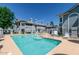 Community pool and seating area surrounded by well-maintained landscaping at 2910 W Marconi Ave # 105, Phoenix, AZ 85053