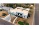 Aerial view of a modern white house with a two-car garage, solar panels, desert landscaping, and a manicured lawn at 3001 E Mulberry Dr, Phoenix, AZ 85016