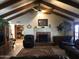 Living room featuring a vaulted ceiling, fireplace, and leather furniture at 3160 E Fox St, Mesa, AZ 85213