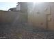 The gravel backyard is surrounded by a privacy fence at 3646 N 67Th Ave # 75, Phoenix, AZ 85033
