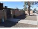 Exterior view of the property featuring walkways, a gate, and mature landscaping at 3646 N 67Th Ave # 75, Phoenix, AZ 85033