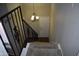 The stairway is carpeted and has a chandelier overhead at 3646 N 67Th Ave # 75, Phoenix, AZ 85033