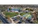 Aerial view of a community park with a lake, fountains, and sports facilities at 40520 W Haley Dr, Maricopa, AZ 85138