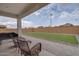 Inviting backyard with patio seating and artificial grass, perfect for entertaining at 40520 W Haley Dr, Maricopa, AZ 85138