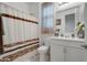 Clean bathroom featuring a shower-tub combo and a vanity with ample storage at 40520 W Haley Dr, Maricopa, AZ 85138