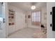 Charming bedroom with a murphy bed, built-in shelving, and a bright workspace near the window at 40520 W Haley Dr, Maricopa, AZ 85138