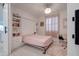 Charming bedroom featuring a Murphy bed, white built-in shelves, and a cozy pink rug at 40520 W Haley Dr, Maricopa, AZ 85138