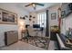 This music room showcases a sleek ceiling fan and an elegant desk setup, plus cool instruments at 40520 W Haley Dr, Maricopa, AZ 85138