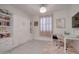 Versatile bedroom with a murphy bed, desk area, and ample storage, ideal for a home office at 40520 W Haley Dr, Maricopa, AZ 85138