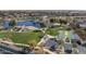Beautiful community park featuring a pond, walking paths, basketball court, and green spaces at 40520 W Haley Dr, Maricopa, AZ 85138