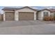 Charming home with a three-car garage, tile roof, and a paved driveway at 40520 W Haley Dr, Maricopa, AZ 85138