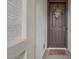 Inviting front door with a decorative wreath and a 'hello' doormat at 40520 W Haley Dr, Maricopa, AZ 85138