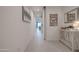 Bright hallway with light wood floors and white walls, leading to the living area at 40520 W Haley Dr, Maricopa, AZ 85138