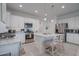 Modern kitchen with stainless steel appliances, white cabinets, and granite countertops at 40520 W Haley Dr, Maricopa, AZ 85138