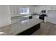 Bright kitchen featuring white cabinetry, granite countertops, stainless steel appliances, and a central island at 4215 N Roble Cir, Eloy, AZ 85131