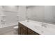 Bathroom with double sink vanity, shower-tub combo, and modern fixtures at 42850 W Palo Abeto Dr, Maricopa, AZ 85138