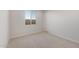 Bright bedroom featuring neutral carpet, white walls, a large window, and ample natural light at 42850 W Palo Abeto Dr, Maricopa, AZ 85138