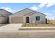 Charming single-story home featuring a neutral color palette, low maintenance desert landscaping, and attached two-car garage at 42850 W Palo Abeto Dr, Maricopa, AZ 85138