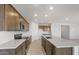 Gourmet kitchen features an island, stainless appliances, shaker cabinets, and tile backsplash at 42850 W Palo Abeto Dr, Maricopa, AZ 85138