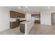 This modern kitchen features an island, stainless appliances, and shaker cabinets at 42850 W Palo Abeto Dr, Maricopa, AZ 85138