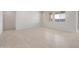 Spacious living area featuring neutral tile flooring, recessed lighting, and large windows that provide ample natural light at 42850 W Palo Abeto Dr, Maricopa, AZ 85138