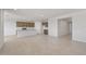 Spacious open-concept design connects the kitchen, and living areas with recessed lighting and neutral tile flooring at 42850 W Palo Abeto Dr, Maricopa, AZ 85138