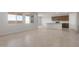 Spacious living area with neutral tile flooring and lots of windows to let in natural light at 42850 W Palo Abeto Dr, Maricopa, AZ 85138