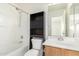 Bathroom features a shower-tub combo, modern sink, and storage cabinet at 44792 W Paitilla Ln, Maricopa, AZ 85139