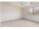 Bright bedroom with ample natural light, neutral carpet, and a ceiling fan, creating a relaxing space at 44792 W Paitilla Ln, Maricopa, AZ 85139