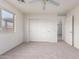 Well-lit bedroom with natural light, spacious closet, neutral carpet and a ceiling fan, creating a comfortable ambiance at 44792 W Paitilla Ln, Maricopa, AZ 85139