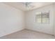 Bright bedroom with light carpet and a large window providing natural light at 44792 W Paitilla Ln, Maricopa, AZ 85139