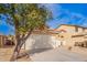 Exterior elevation of a single-story home in a desert landscape with a tile roof at 44792 W Paitilla Ln, Maricopa, AZ 85139