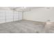 Well-lit garage with a concrete floor, ready for parking and storage solutions at 44792 W Paitilla Ln, Maricopa, AZ 85139