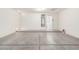 Spacious garage showcasing a smooth concrete floor and ample room for storage at 44792 W Paitilla Ln, Maricopa, AZ 85139